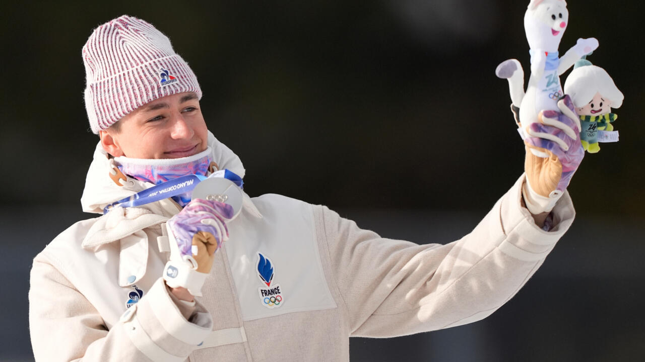 Eric Perrot, of France, poses with the silver medal for the men