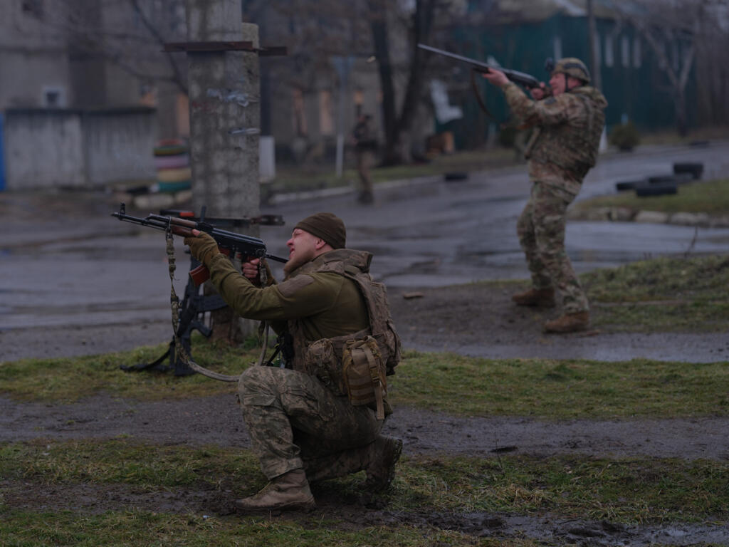 In this photo provided by Ukraine's 93rd Kholodnyi Yar Separate Mechanized Brigade press service, soldiers fire at a Russian FPV drone on the frontline in Druzhkivka, Donetsk region.