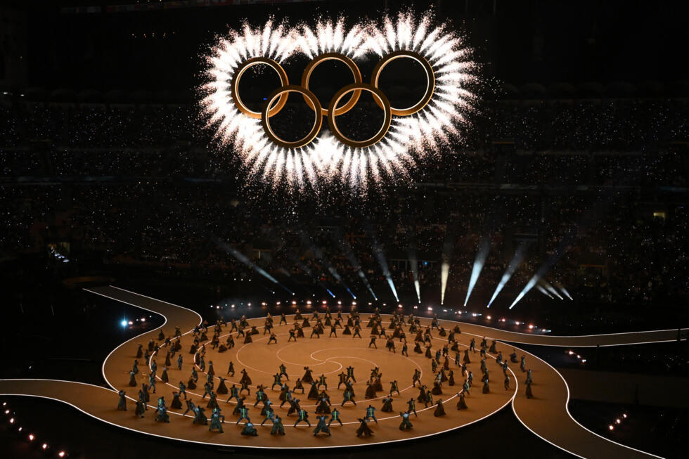 The Olympic Rings is revealed above dancers during the opening ceremony of the Milano Cortina 2026 Winter Olympic Games at the San Siro stadium in Milan, northern Italy, on February 6, 2026. 