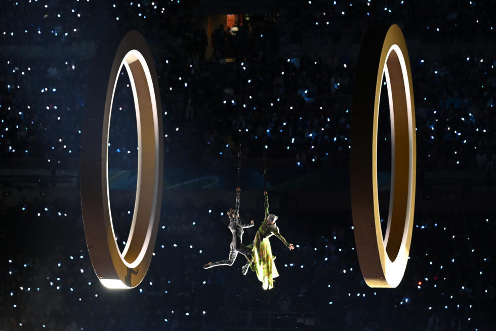 Rings start to form the Olympic symbol during the opening ceremony of the Milano Cortina 2026 Winter Olympic Games at the San Siro stadium in Milan, northern Italy, on February 6, 2026. 