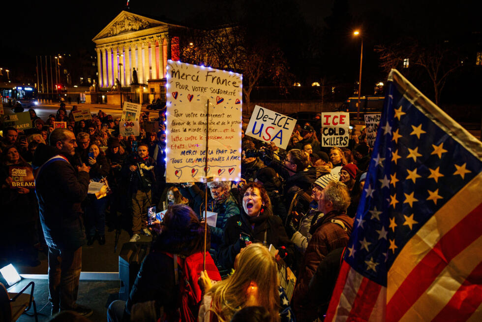 Protesters hold placards as they take part in a rally against US President Donald Trump's policies in front of the National Assembly in Paris on January 28, 2026