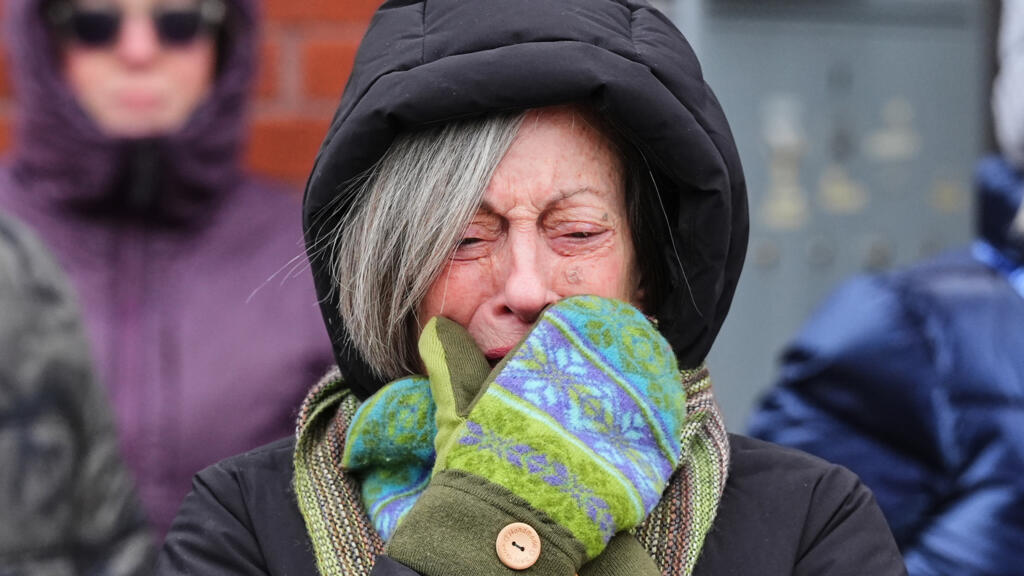 A woman crying at a makeshift memorial for Alex Pretti, a 37-year-old man fatally shot by a U.S. Border Patrol officer over the weekend. 