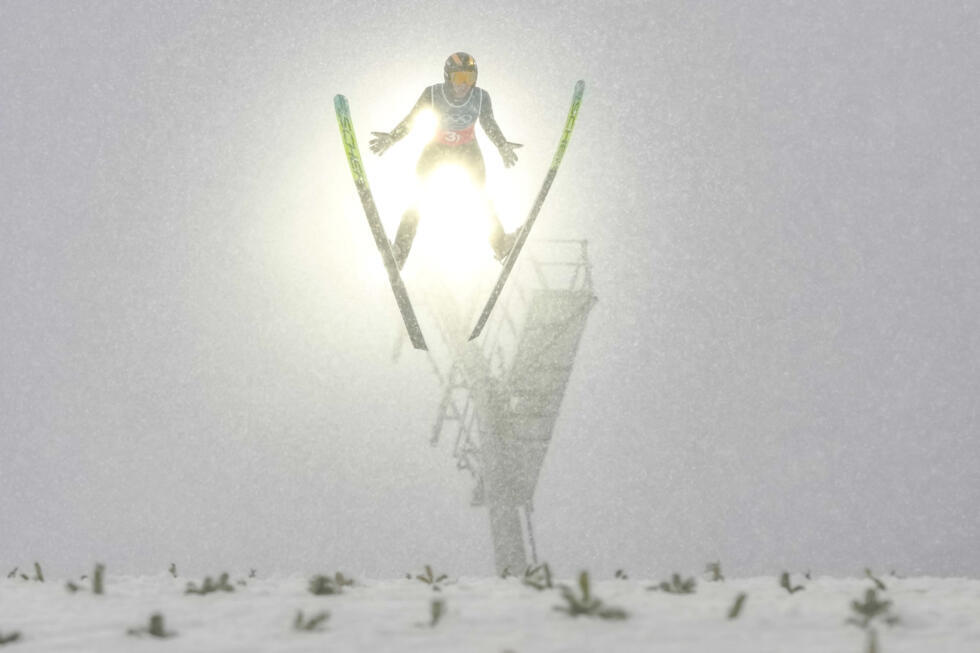 ZZhao Zihe, of China, soars through the air at the 2026 Winter Olympics, in Predazzo, Italy, Thursday, February 19, 2026