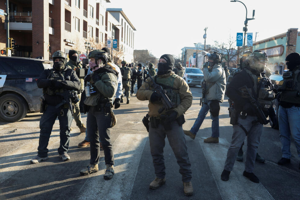 Federal agents stand guard at the scene of the fatal shooting of Alex Jeffrey Pretti by federal immigration agents in Minneapolis, on January 24