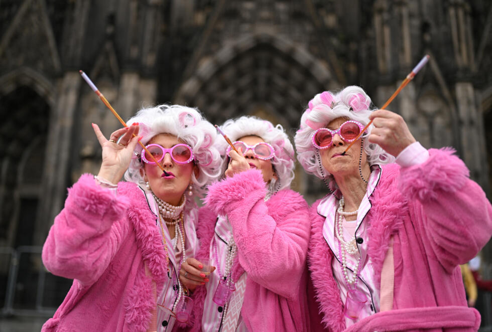 Revellers arrive for the start of Women's Carnival Day in Cologne, western Germany, on February 12, 2026.