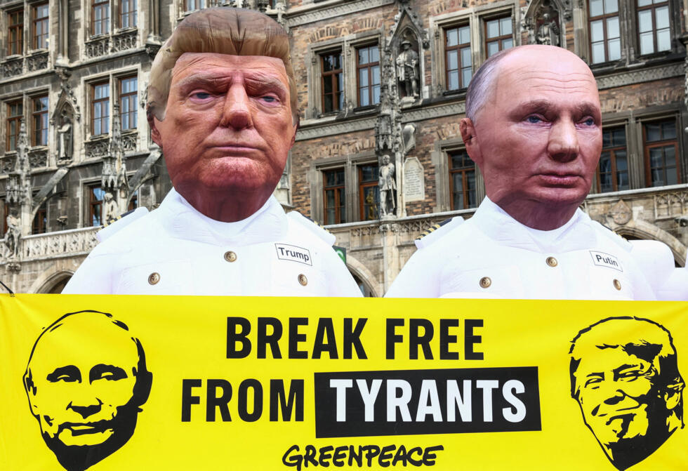 Greenpeace activists wearing masks of US President Donald Trump and Russian President Vladimir Putin protest against the Munich Security Conference