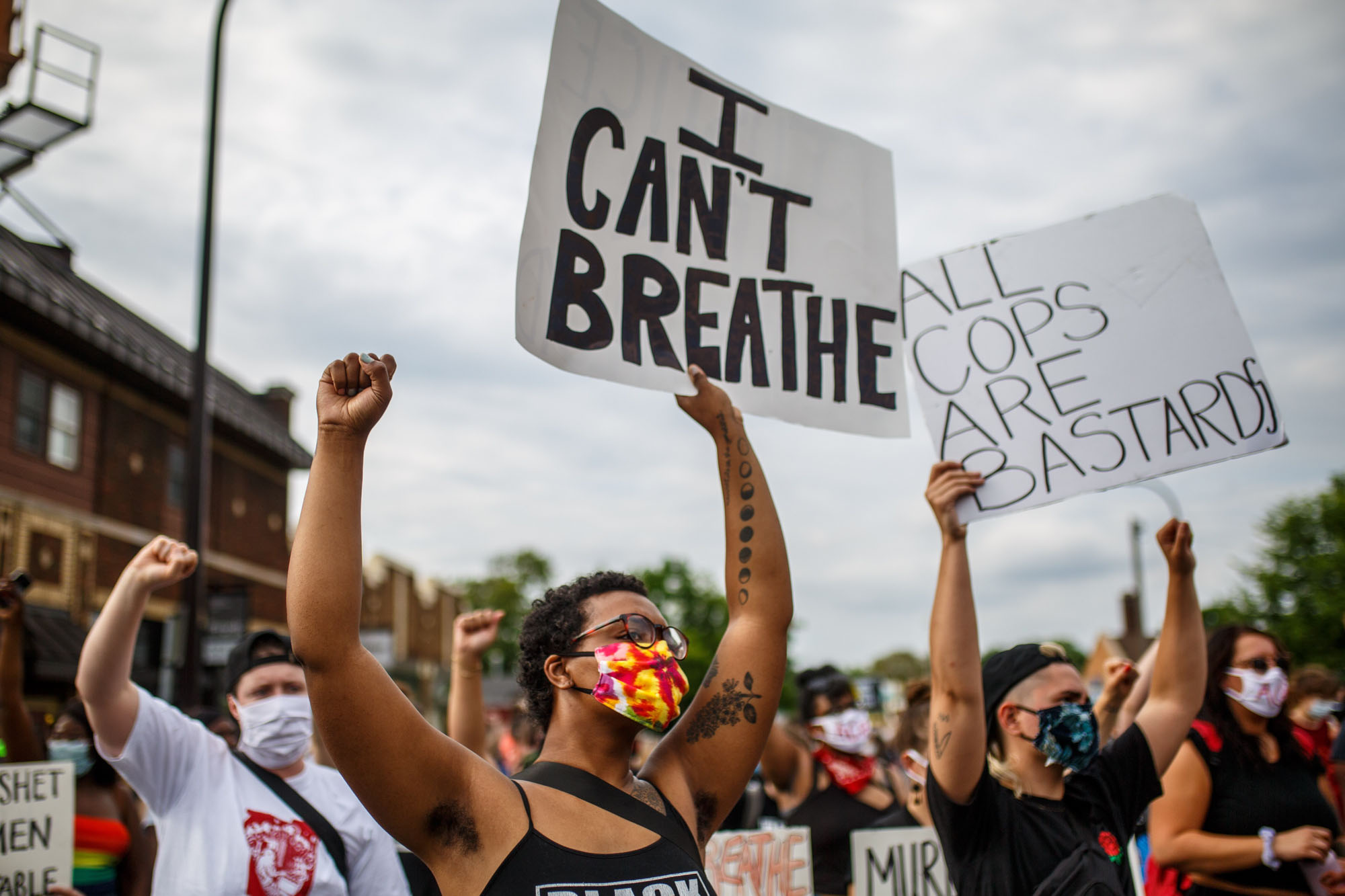People hold signs and protest after a Minneapolis Police Department officer allegedly killed George Floyd, on May 26, 2020 in Minneapolis, Minnesota. - A video of a handcuffed black man dying while a Minneapolis officer knelt on his neck for more than five minutes sparked a fresh furor in the US over police treatment of African Americans Tuesday. 