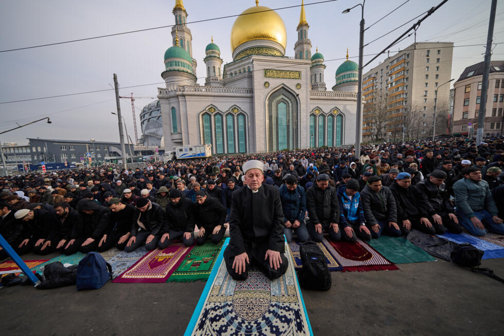 Muslims pray outside the Moscow Cathedral Mosque during celebrations of Eid al-Fitr holiday in Moscow, Russia.