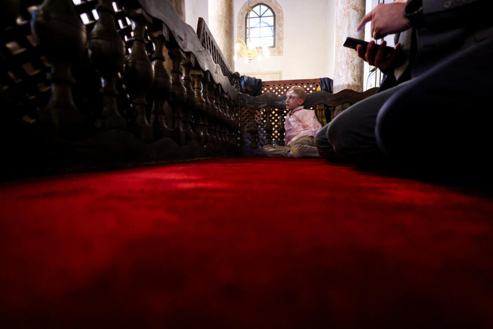 A Muslim boy attends Eid al-Fitr prayers marking the end of the holy fasting month of Ramadan at Gazi Husrev-beg Mosque in Sarajevo, Bosnia and Herzegovina.