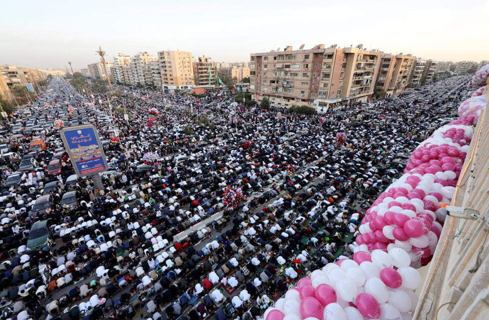 People attend an Eid al-Fitr prayer, marking the end of the Muslim holy fasting month of Ramadan, outside El-Seddik Mosque in Cairo, Egypt.