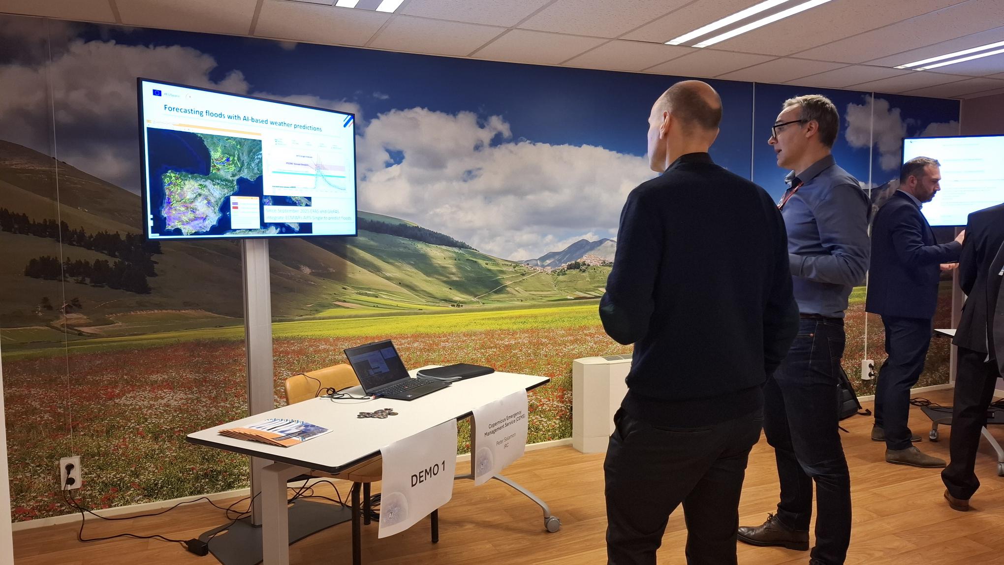 A photo of a demonstration display of AI4FloodDamage with the Head of Copernicus Emergency Management Service, Peter Salamon.