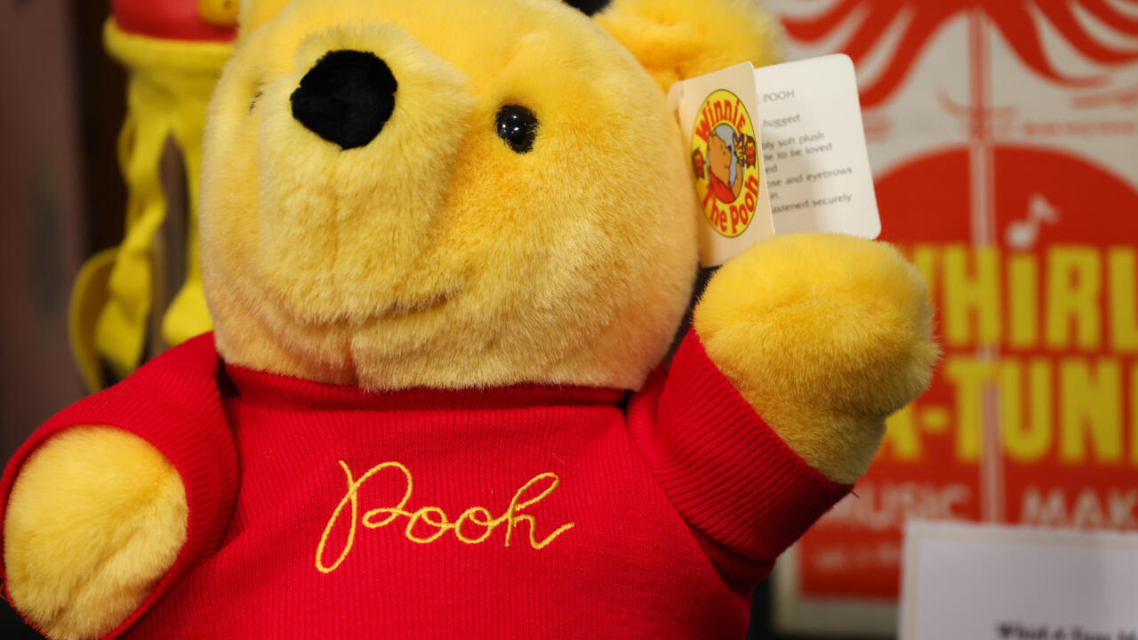 A member of the Walt Disney Studios Archive staff displays a vintage Winnie the Pooh book