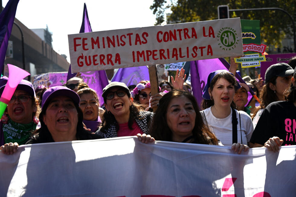 A woman holds a banner reading "Feminists against imperialist war" during a demonstration marking International Women's Day in Santiago on March 8, 2026.