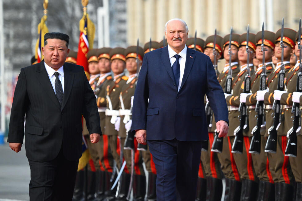 North Korea's leader Kim Jong Un, left, and Belarusian President Alexander Lukashenko attend an official meeting ceremony in Pyongyang, North Korea.