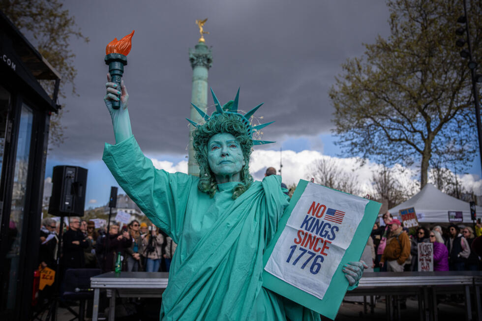 A woman dressed as the Statue of Liberty takes part in the "No Kings" protest in Paris, France, Saturday, March 28, 2026.
