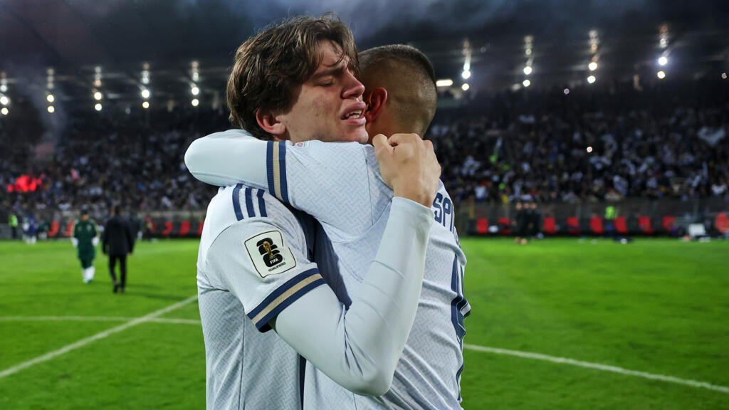 Italy's Marco Palestra, left, and Leonardo Spinazzola console each other after losing a penalty shootout during the World Cup qualifying playoff match between Bosnia and Italy in Zenica, Bosnia