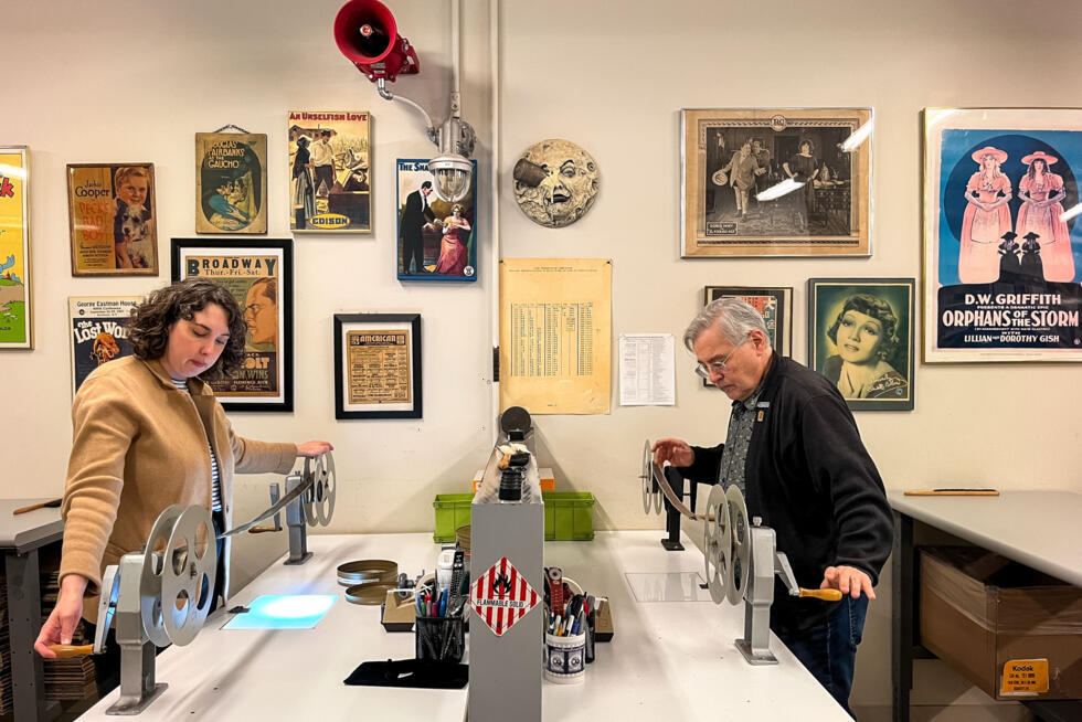 Nitrate Film Vault technician Courtney Holschuh (L) and vault leader George Willeman (R) unspool film on reels at the Library of Congress Audio-Visual Conservation Center