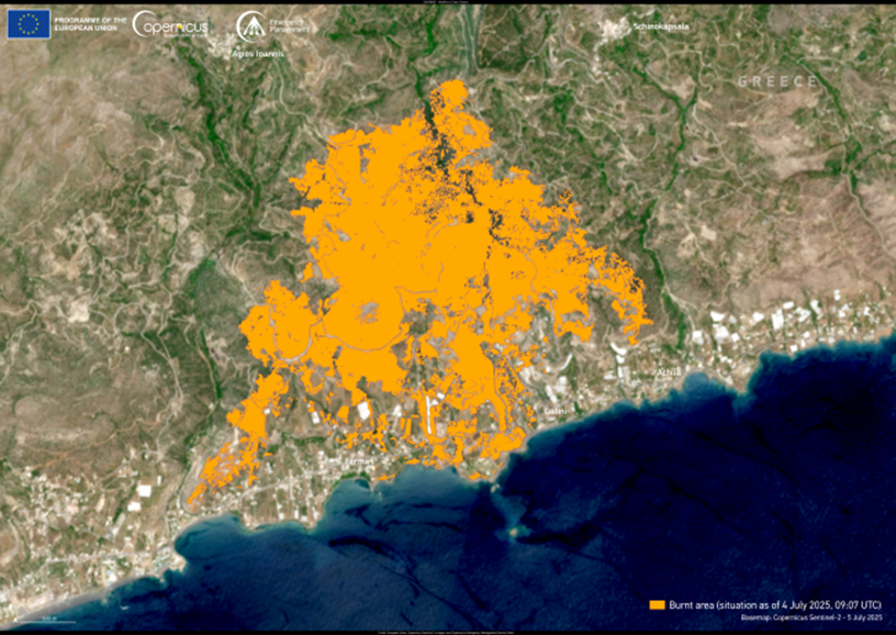 A satellite image of a coastal area in eastern Crete, Greece, with the burnt area of the Achlia wildfires highlighted in orange. The burnt area forms a large, irregular shape covering a significant portion of the inland terrain, extending close to the coastline in the south.