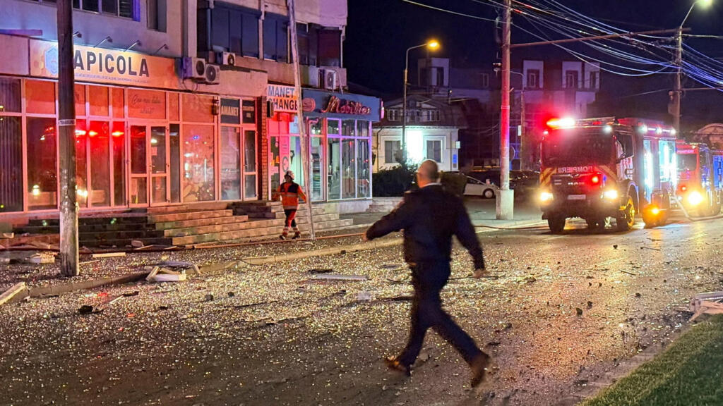 Firefighters and law enforcement work at the site of an explosion at a residential block of flats following a drone hit close to the border with Ukraine, in Galati, Romania.