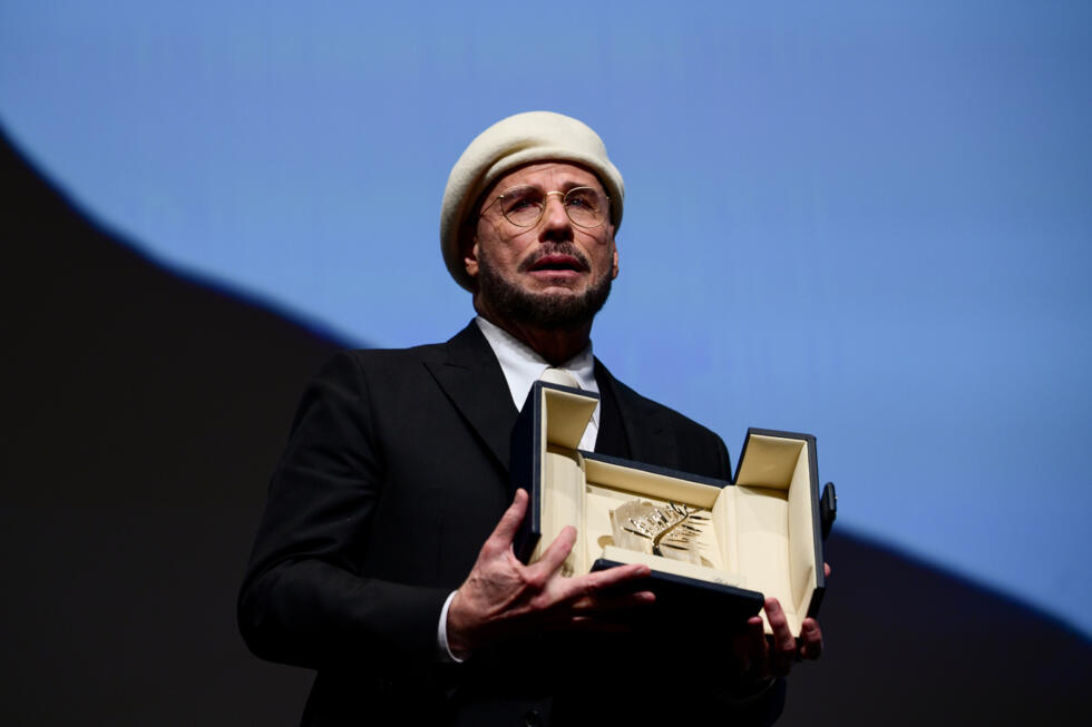 John Travolta cries as he receives a Palme d'Or lifetime achievement award at the Cannes Film Festival