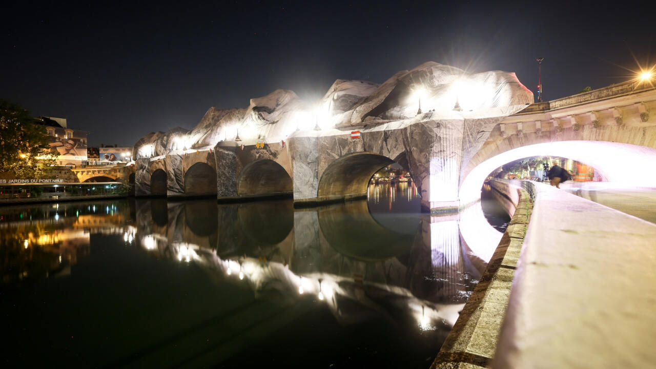 French street artist JR prepares the inflation of his artwork "The Pont Neuf Cave" on Pont Neuf bridge, May 20, 2026, in Paris.