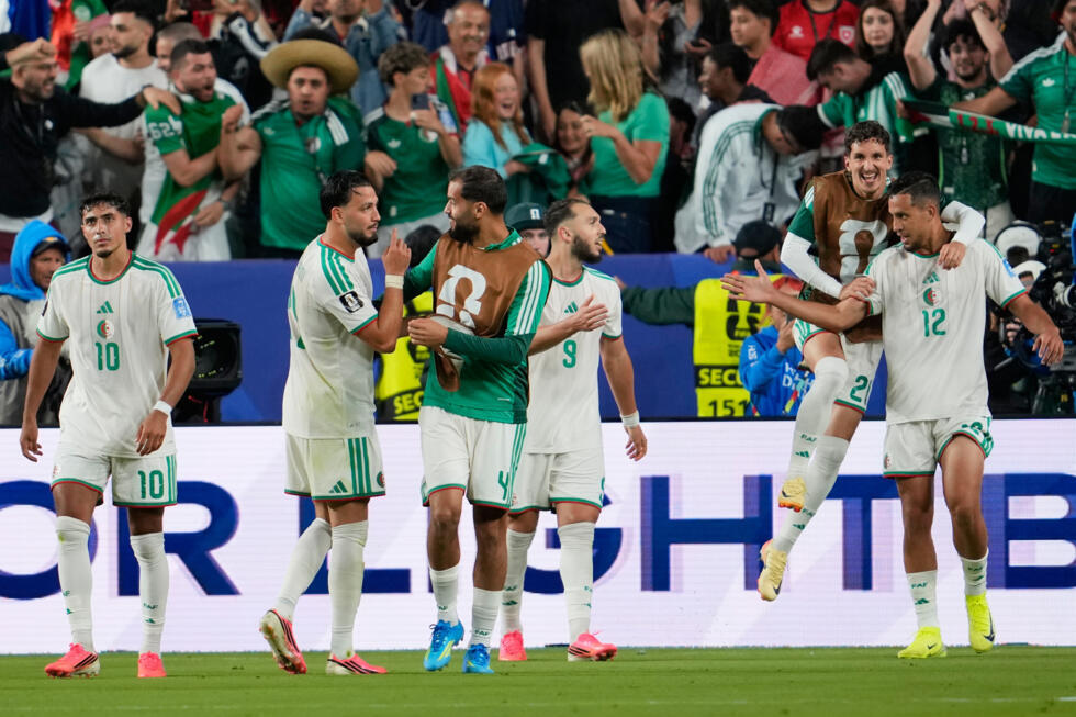 Algeria's Amine Gouiri celebrates with teammates after scoring his side's second goal against Jordan.