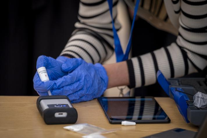the photo displays a person testing new technology to detect drugs