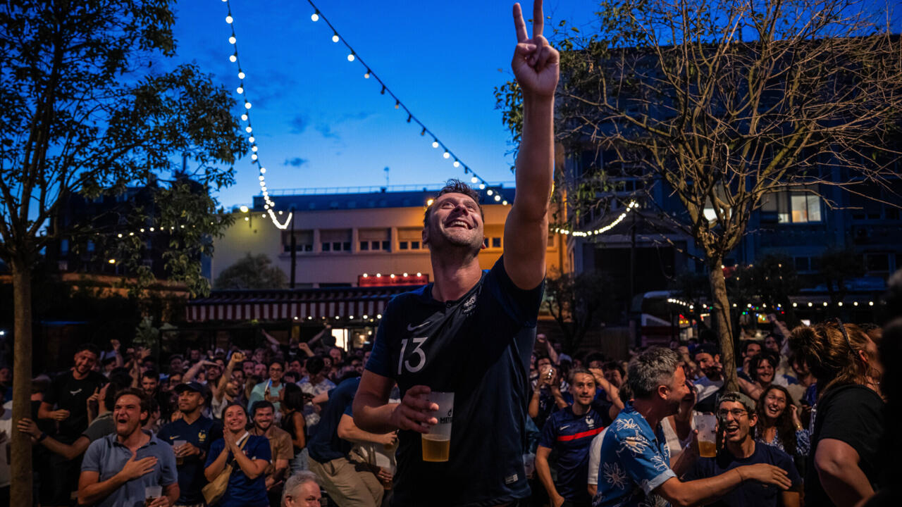French fans react as they watch a broadcast of the World Cup Group I soccer match between France and Senegal on June 16, 2026, in Paris