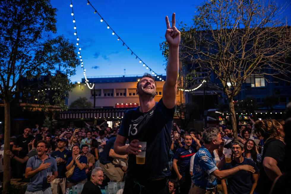 French fans react as they watch a broadcast of the World Cup Group I soccer match between France and Senegal on June 16, in Paris