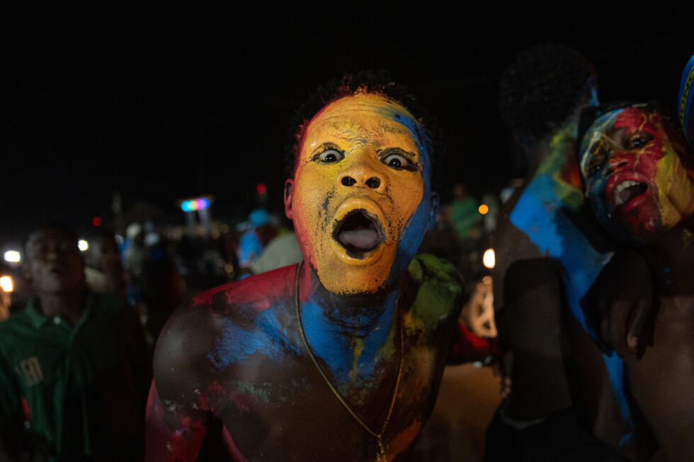Supporters dressed in the colors of the Democratic Republic of Congo's national flag celebrate in Bunia, Ituri Province as the Leopards' equalize against Portugal in a FIFA World Cup match on June 17