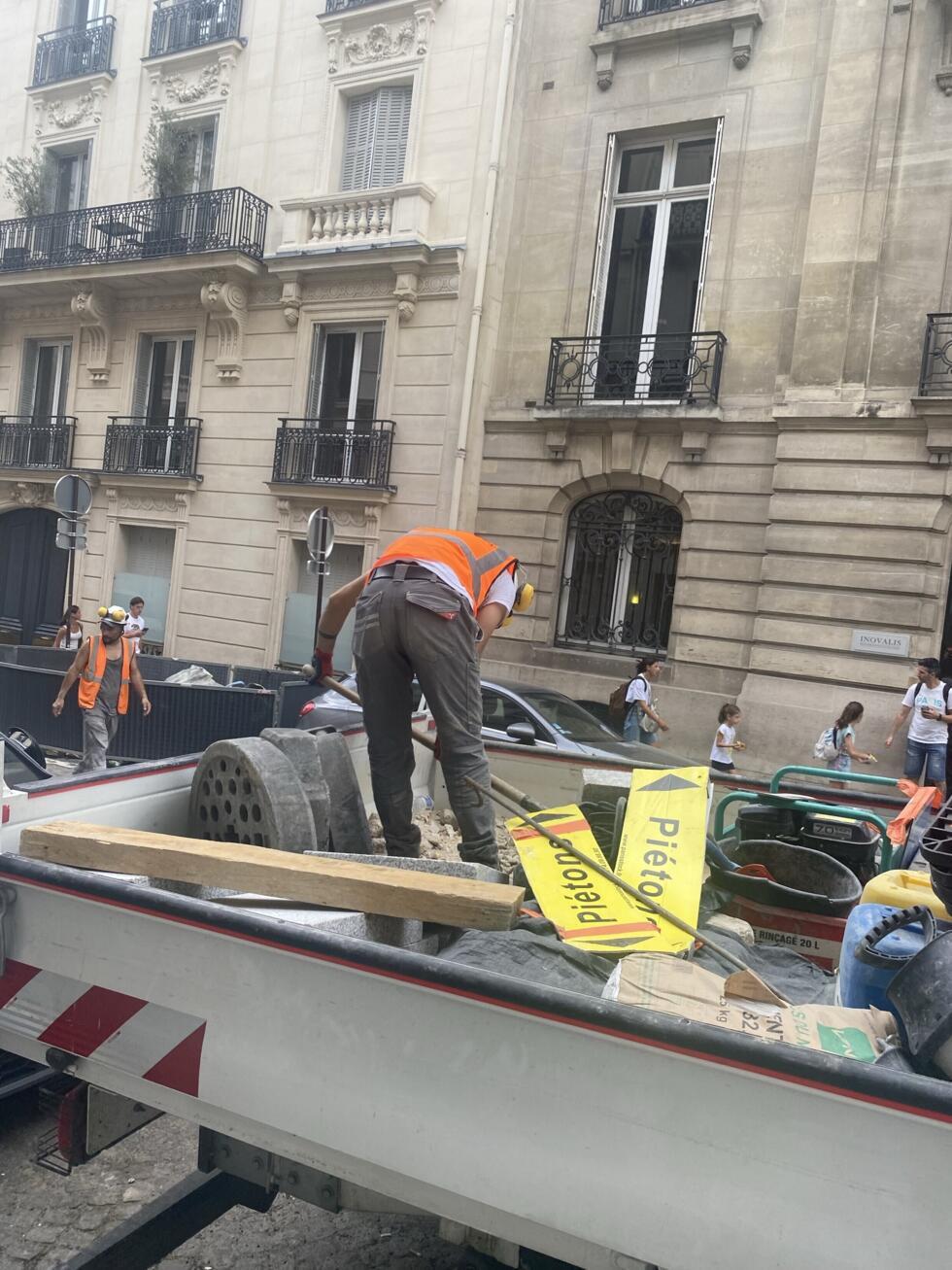 Construction workers labour under the rising temperatures